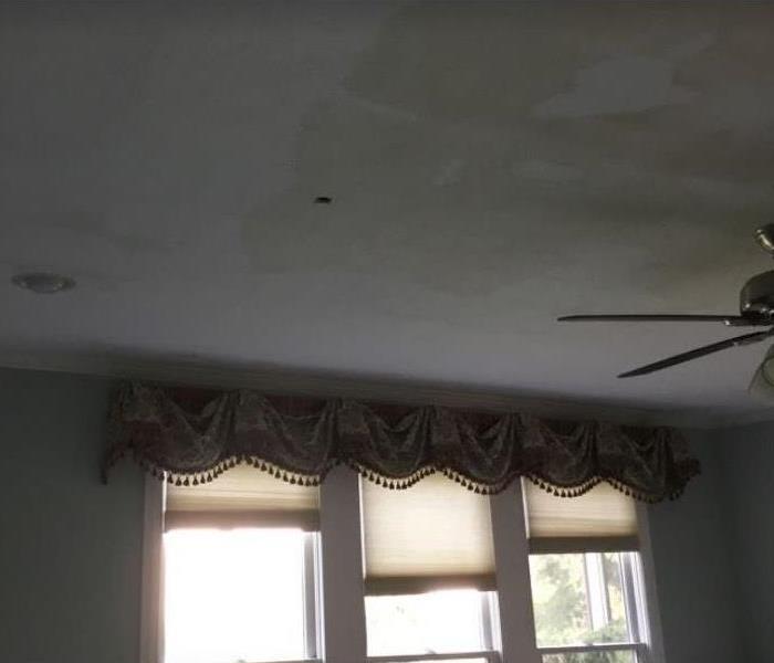 brown water stains on white ceiling 