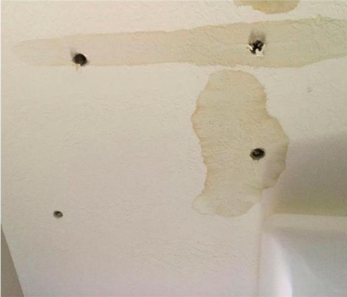 brown water stains on white ceiling