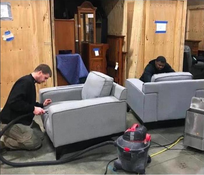 male employees cleaning furniture after loss