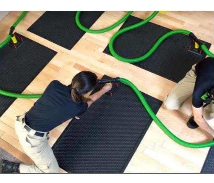 employee using drying floor mats