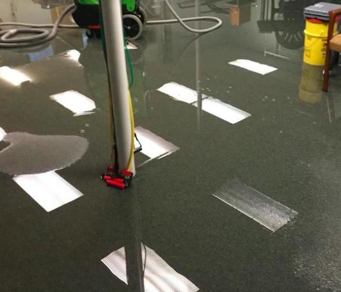 water on black floor in commercial building 