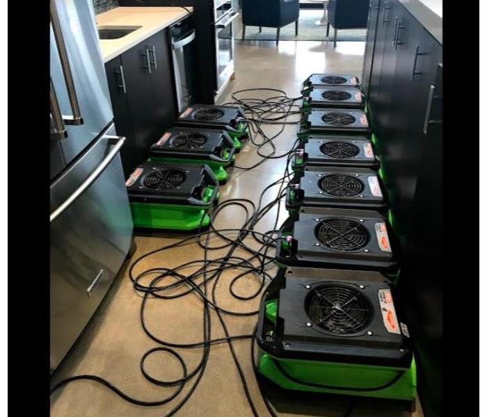 green fans laying on ground in between cabinets